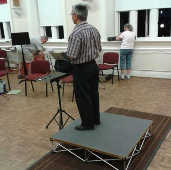 Conductor Podium - Speaker podium, camera podium. This stage podium package offers a very quick setup podium to elevate your conductor, camera equipment, single speaker, or musician. Takes 30 seconds to assemble. Comes in tough top or carpet finish and 300mm riser. No locks or keys. Watch the Video! Add 4m of  Valance Skirting for Conductors podium speaker podium