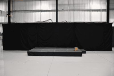 11m wide black event backdrop frame, 3m tall, with three 4x3m frames and black covers